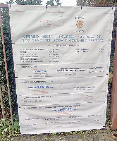 Sopra, l’Adda alla Canottieri, a lato il cartello di cantiere Sopra, l’Adda alla Canottieri, a lato il cartello di cantiere