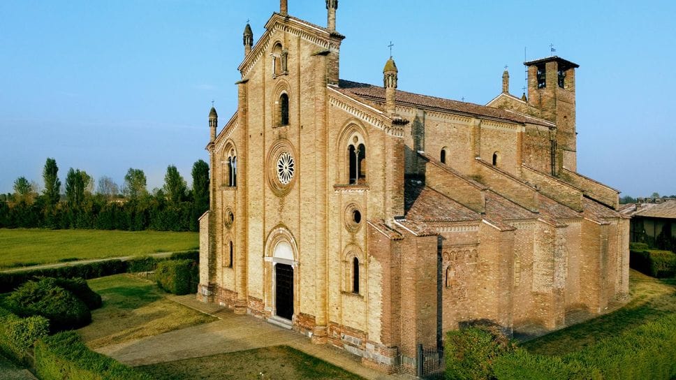 Una veduta aerea della basilica, solitaria tra i campi di Laus Pompeia